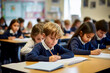© RCH Photographic - Primary school children in blue uniform in the classroom writing in their books elementary students attending a class academic concept children in a lesson little children sitting at their desks