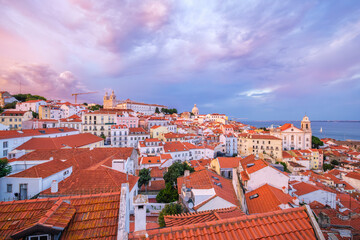 Wall Mural - View of Lisbon famous view from Miradouro de Santa Luzia tourist viewpoint over Alfama old city district on sunset with dramatic overcast sky. Lisbon, Portugal.