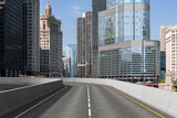 Fototapeta Nowy Jork - Empty urban asphalt road exterior with city buildings background. New modern highway concrete construction. Concept of way to success. Transportation logistic industry fast delivery. Chicago. USA.