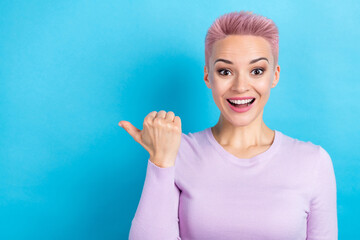 Photo of excited pretty girl showing low price sale banner empty space wear casual trendy lilac shirt isolated blue color background