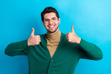 Sticker - Photo of satisfied glad young man beaming smile arms fingers demonstrate thumb up isolated on blue color background