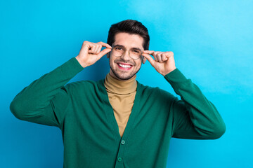 Sticker - Photo of cheerful positive man wear green cardigan arms spectacles smiling isolated blue color background