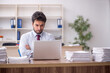 © Elnur - Young male employee and too much work in the office