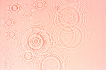 Wall Mural - Pink transparent water texture with circles from drops