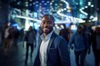© CYBERUSS - Portrait of Happy African American Businessman Walking on Street at Night, Smiling Black Manager in Modern City Surrounded By Blurred People.