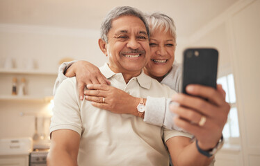 Canvas Print - Senior couple, home and smile with smartphone for video call, mobile streaming and scroll on social media in retirement. Happy old man, woman and hug with phone for selfie, reading news app and relax