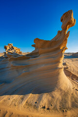 Wall Mural - Desert eroded rock pattern with clear sky. Desert rock formation with erosion