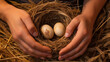 A pair of hands gently cradling a freshly laid, speckled brown egg in a nest of straw