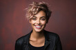 © Sergio - Positive laughing stylish woman with short haircut, hairstyle, make-up and in a leather jacket smiling looking at camera, casual female portrait