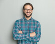 © Viorel Sima - portrait of proud young man with glasses crossing arms and smiling