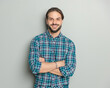 © Viorel Sima - proud casual man in plaid shirt crossing arms and smiling