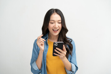 Wall Mural - Happy Asian woman holding a smartphone and winning the prize.