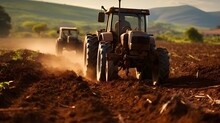Agriculture. Tractor Plowing Field. Wheels Covered In Mud, Field In The Backround. Cultivated Field. Agronomy, Farming, Husbandry Concept.