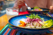 Peruvian-style ceviche plate in outdoor dining, Pisco Sour cocktail