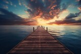 Fototapeta  - wooden dock pier on the water at sunset, sea summer background with beautiful landscape