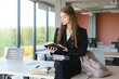 © Serhii - Schoolgirl standing with books and backpack at school.