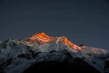 mountain peak in the snow at Sunset light