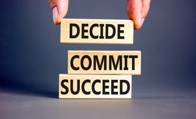 Wall Mural - Decide commit succeed symbol. Concept word Decide Commit Succeed on beautiful wooden block. Businessman hand. Beautiful grey table background. Business decide commit succeed concept. Copy space.