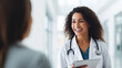 © Mosaic Media - A female doctor discusses with a smiling patient in a hospital, reflecting a positive and compassionate healthcare interaction.