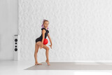 Rhythmic gymnastics. Preteen girl athlete rhythmic gymnastic in black suit does exercise with ball.