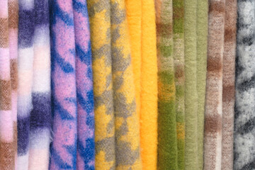 Poster - Mix colorful hanging vertical stripe textile, fabrics, cloths on the rack. Texture of multicolored fabrics close up.