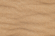 Close-up  Background Brown Sand Wave With Rippled Dunes. Top View. Space For Text. Sand Summer Texture.