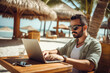 Young freelancer working on laptop from tropical destination.