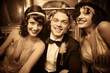 1920s Happy Group Portrait. A joyful group of flapper girls and dapper gentlemen posing at a jazz age speakeasy, exuding the carefree spirit of the Roaring Twenties. Vintage camera, sepia Tone.
