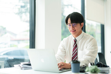 Wall Mural - Businessman using laptop to typing data and working about financial of business in modern workplace