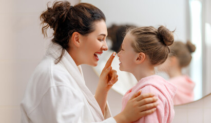 Mother and daughter caring for skin