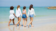 © NVB Stocker - Group of teenager girls walking on beach. Four teenager girl female enjoying and walking on tropical beach. Vacation trip summer holiday.