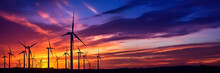 Wind turbines farm agaist the colorful sky at sunset. Renewable and Alternative energy.