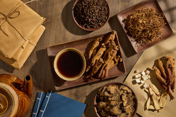 Canvas Print - A wooden dish in rectangle-shaped featured a bowl of tonic and Red ginseng. Other herbal medicine types are surrounded with books, earthen pot and medicine packs