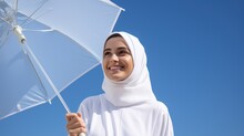 A Successful Arab Woman Holding A White Umbrella Against A Blue Sky