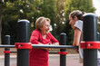 © Westend61 - Grandmother and granddaughter training on bars in a park