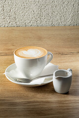 Poster - cup of cappuccino on wooden table