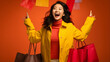 Close-up of an exuberant Asian woman flaunting her vibrant shopping haul