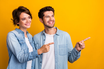 Fototapete - Photo of satisfied cheerful family wear stylish denim clothes demonstrate recommend offer empty space isolated yellow color background