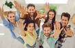 © Studio Romantic - High angle top view from above group portrait team happy smiling young coworker friend people standing in office looking up waving hand saying hello inviting new members to business leader forum event