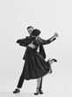 © master1305 - Rhythm and freedom. Black and white. Beautiful young woman in elegant black dress dancing with stylish and handsome man. Concept of hobby, retro dance, vintage style, choreography. Monochrome art. Ad