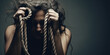 Powerful representation of a tearful woman bound by ropes, symbolizing victimhood in domestic violence. Ideal for awareness campaigns or women's rights initiatives.