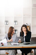 © Nuttapong punna - Two businesswoman discuss investment project working and planning strategy with tablet laptop computer in office..