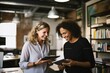 © koala studio - Creative female executives using digital tablet in office