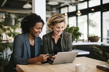 Creative female executives using digital tablet in office