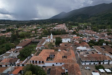 Aerial shot of a Colombian neighborhood with a group of houses and green field in El Cerrito