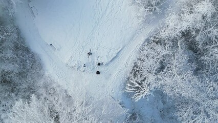 Canvas Print - Descending drone over hikers walking on snowy ground glacier in the park