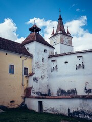 Wall Mural - a tall building that has a clock on the top of it