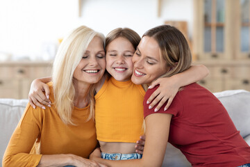 Wall Mural - Happy teen girl hugging beloved mom and grandma at home