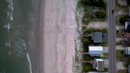 Poster - Bird's eye view around sea waves breaking beach near road and buildings in North Carolina