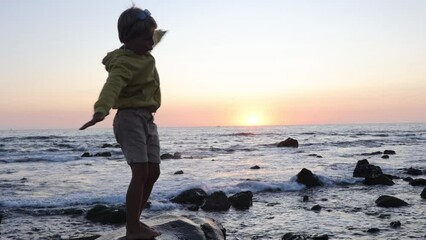 Canvas Print - Happy children, enjoying sunset over the ocean with their family, rocky beach in Portugal